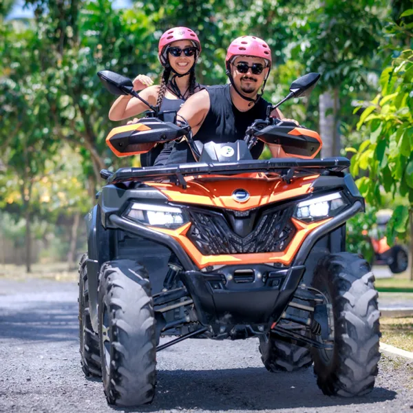 Couple sitting on an ATV and smiling for the camera during the Koh Samui Off-Road Adventure ATV Safari Tour