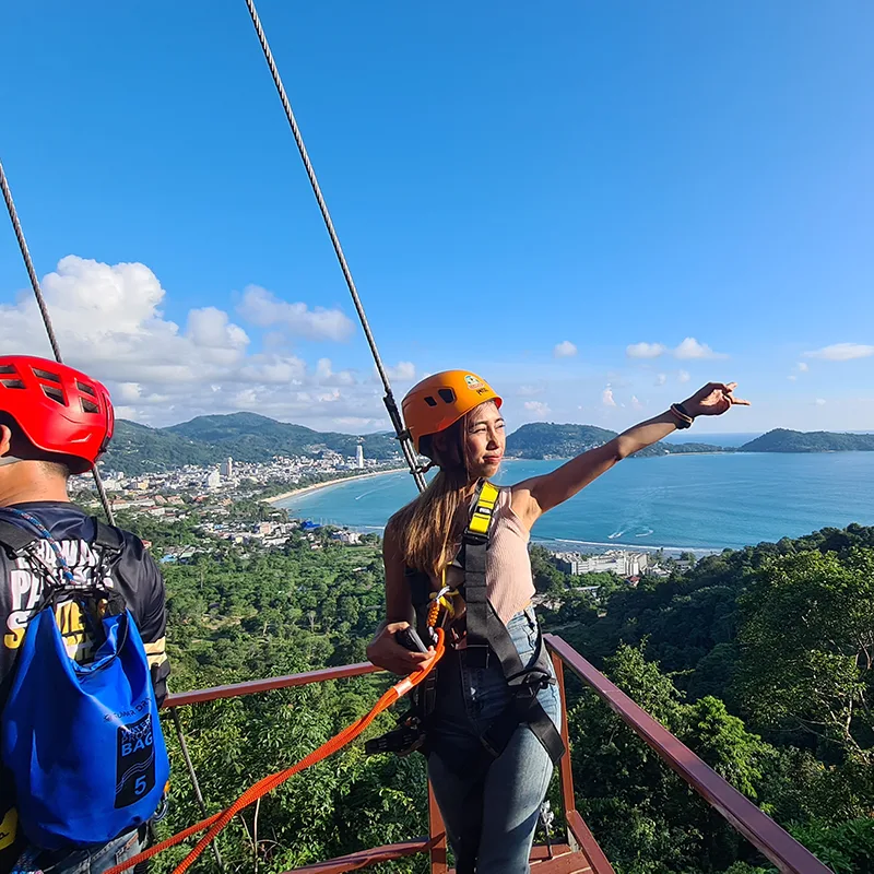 Tourist posing with a beautiful view in the background during the Patong Phuket Adventure Experience at Erawan Seaview Zipline