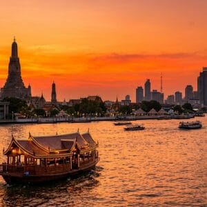 Bangkok first-time visitor guide – dinner cruise on the Chao Phraya River at sunset with the Temple of Dawn in the background
